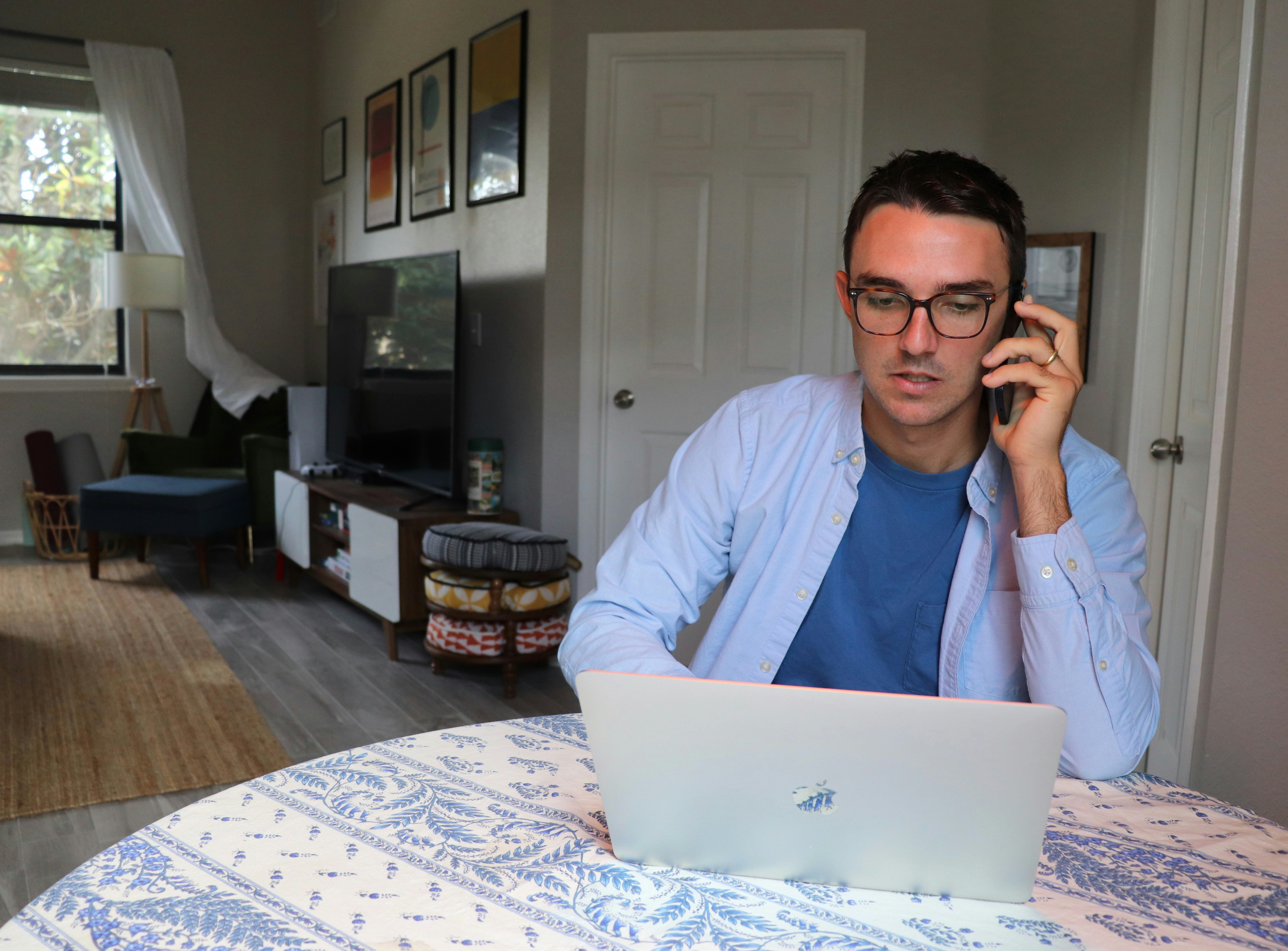 Sales rep on a call reviewing HubSpot deal context on laptop